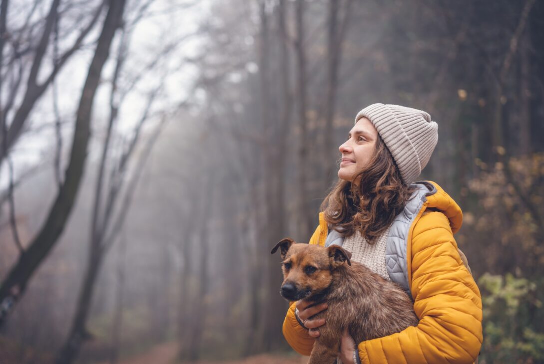 Woman with dog in forest