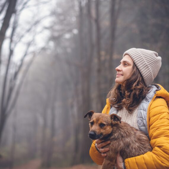 Woman with dog in forest