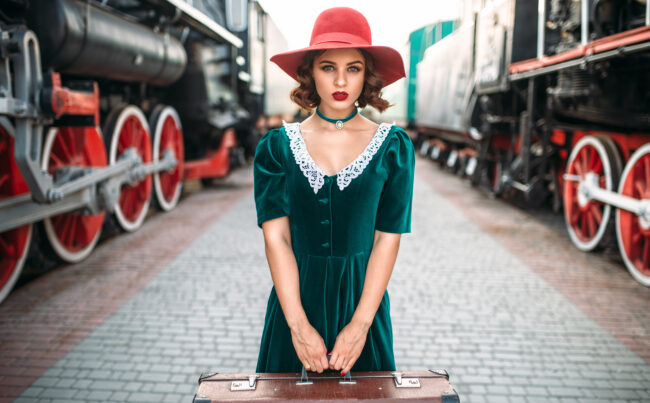 Young old-fashioned woman travels on retro train