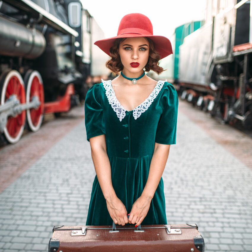 Young old-fashioned woman travels on retro train